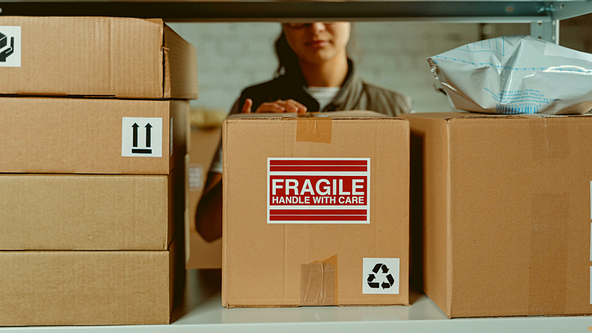 Blog post image for "How to store a grade card?". Image showing cardboard boxes with fragile sign
