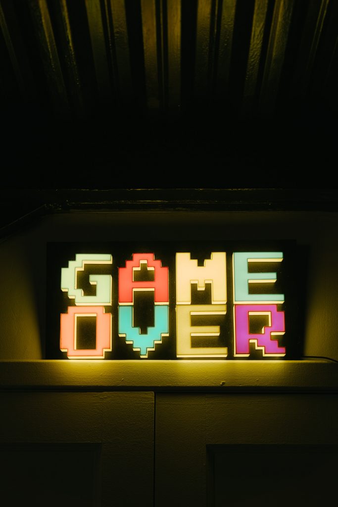 Image with a game over sign. Illustrating that PSA suspends card grading services.